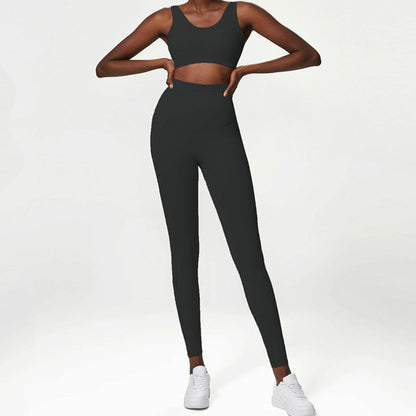 African American model wearing a black, high waisted, squat proof matching workout set from Vibras Activewear.
