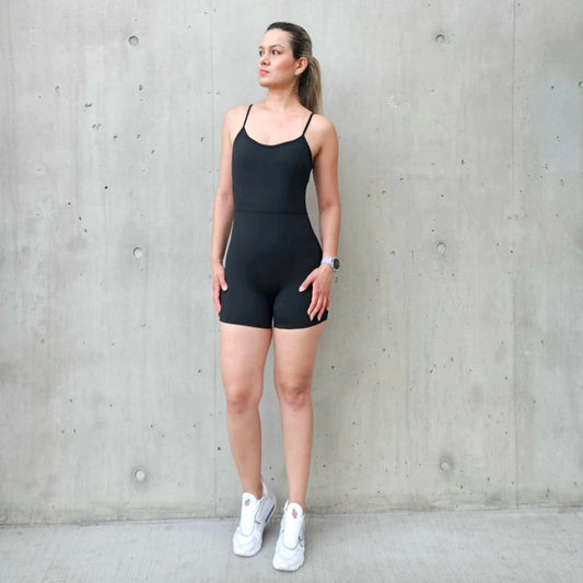Fitness model wearing a black, contouring jumpsuit  from Vibras activewear.