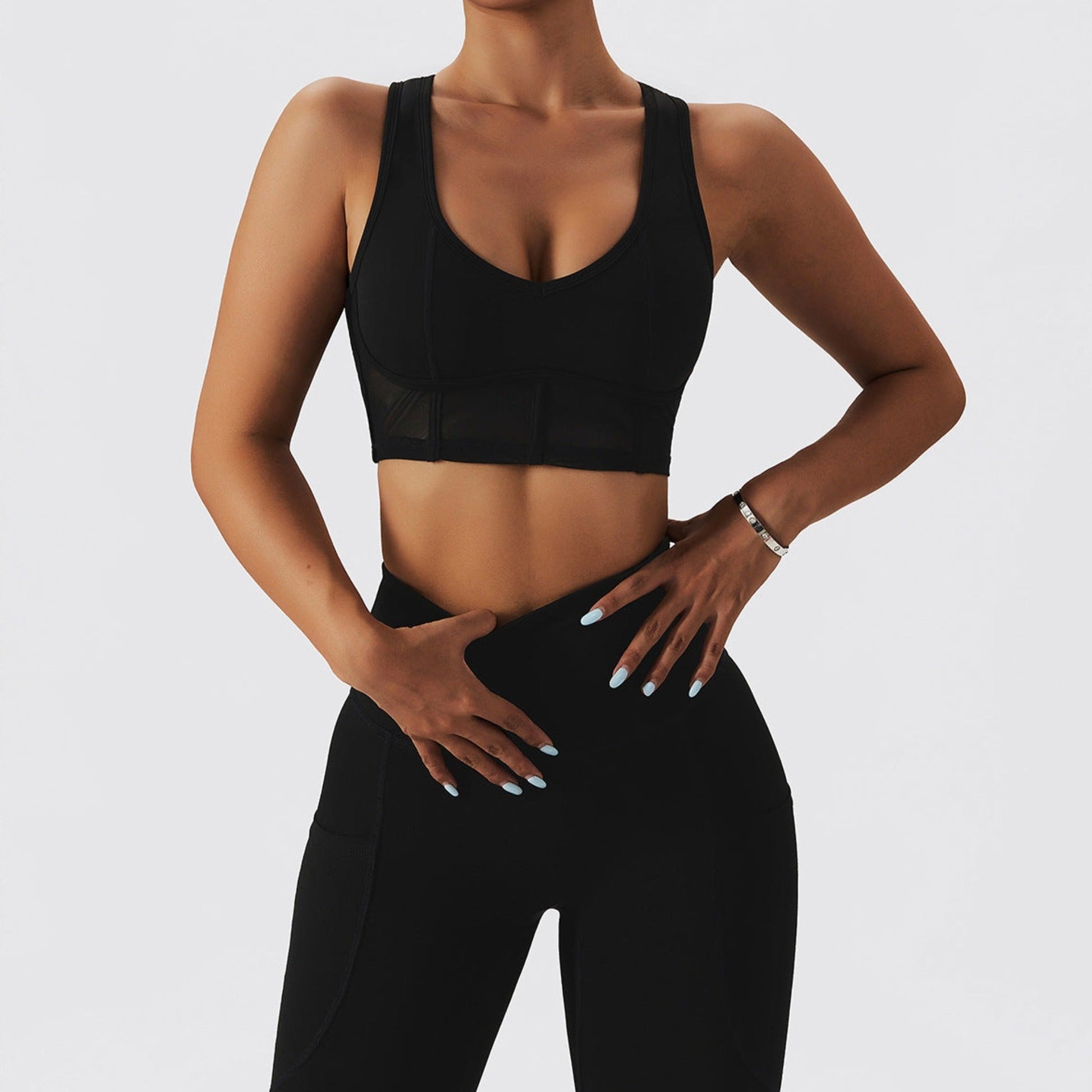 Fitness model wearing a sexy, contouring, black matching set from Vibras Activewear.