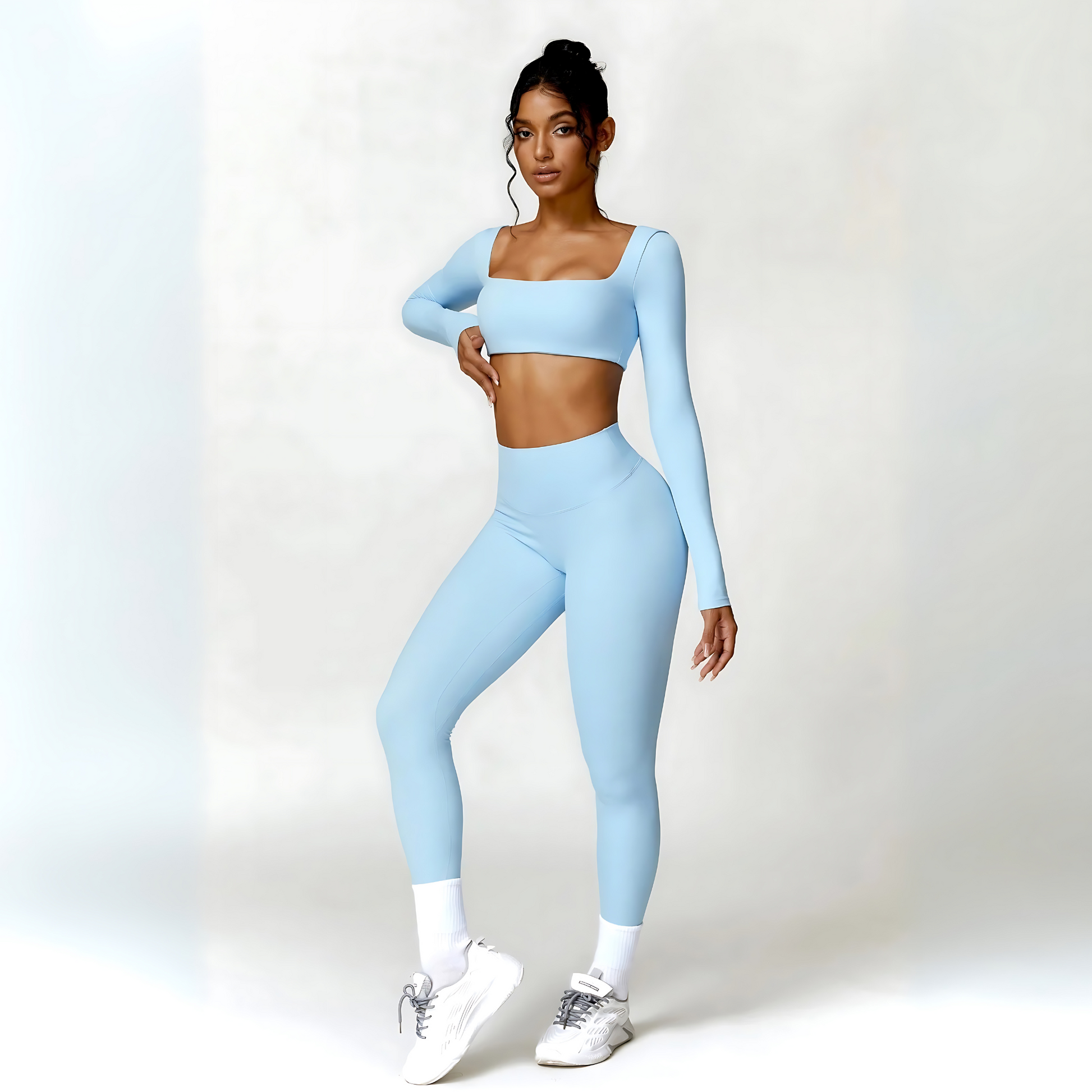 Model wearing the baby blue Valentina set with long sleeve crop top and high-waisted leggings from Vibras Activewear.