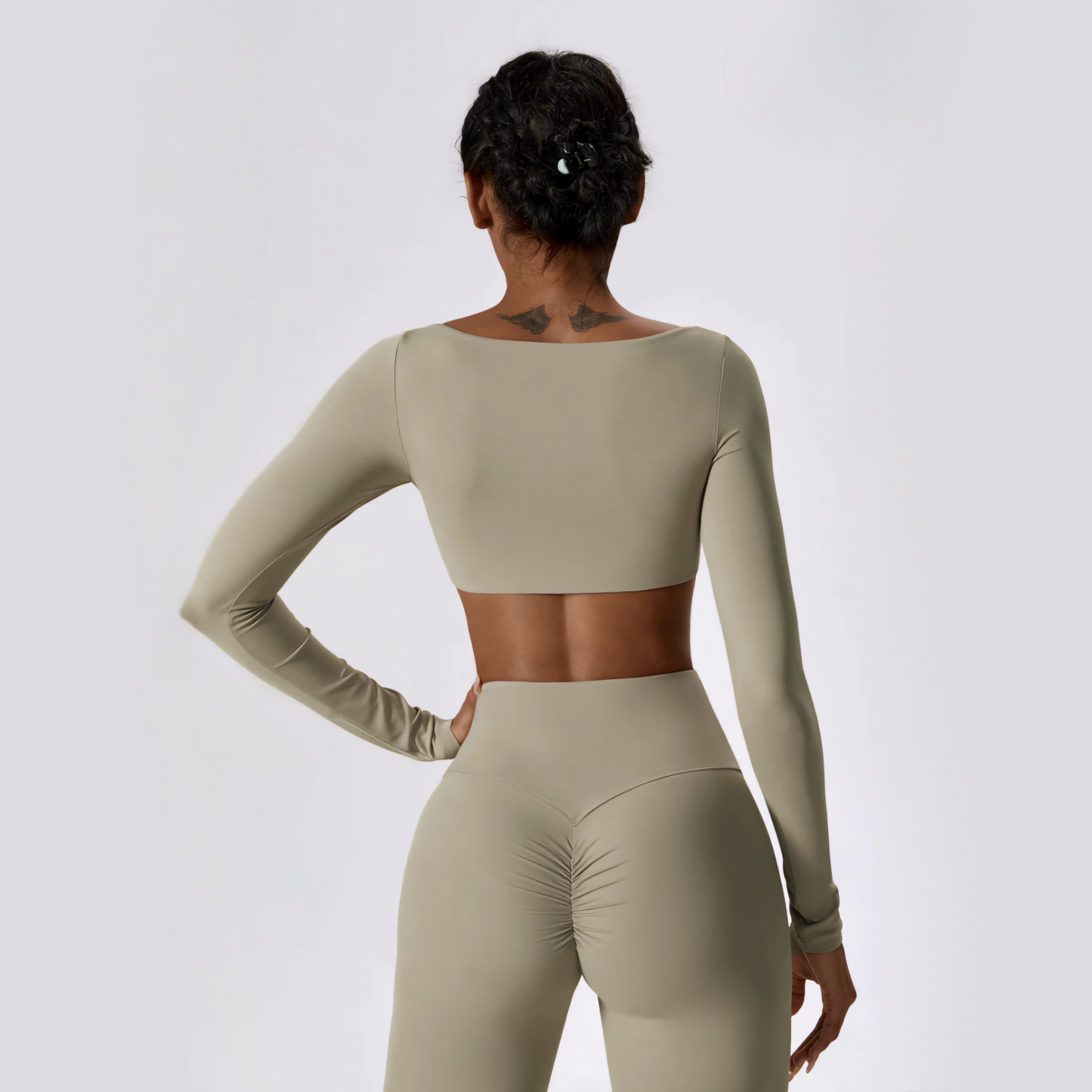Back photo of fitness model wearing the body sculpting and squat proof Anastasia matching workout set in the colour oatmeal from Vibras Activewear.