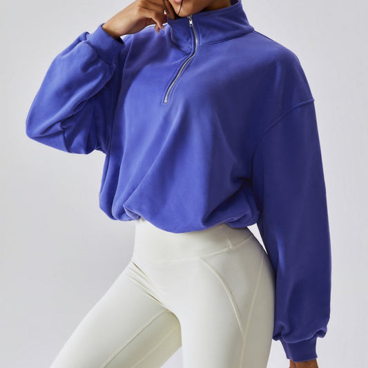 FITNESS MODEL WEARING A INDIGO, CROPPED, PAPER BAG SWEAT SHIRT FROM VIBRAS ACTIVEWEAR.