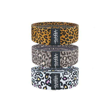 a set of three anti-slip, thick booty resistance bands for workout in three different motives, amber cheetah, grey cheetah and white colourful cheetah on a white background.