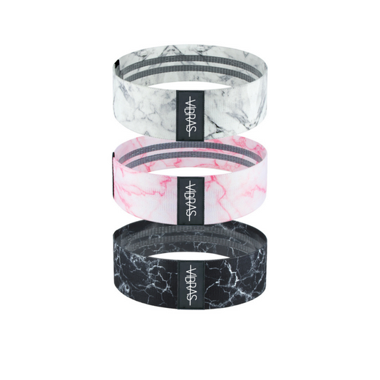 a set of three marble thick booty resistance bands for workout in three different colors white, pink and black on a white background.