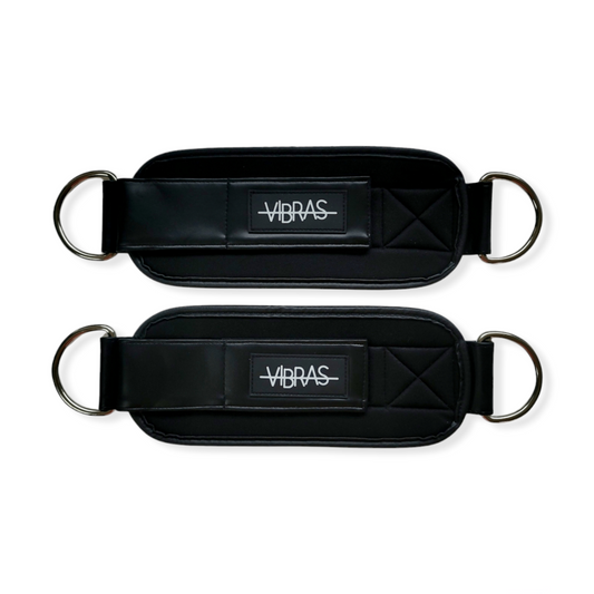 A set of black faux leather ankle cable straps for  workouts in a white background