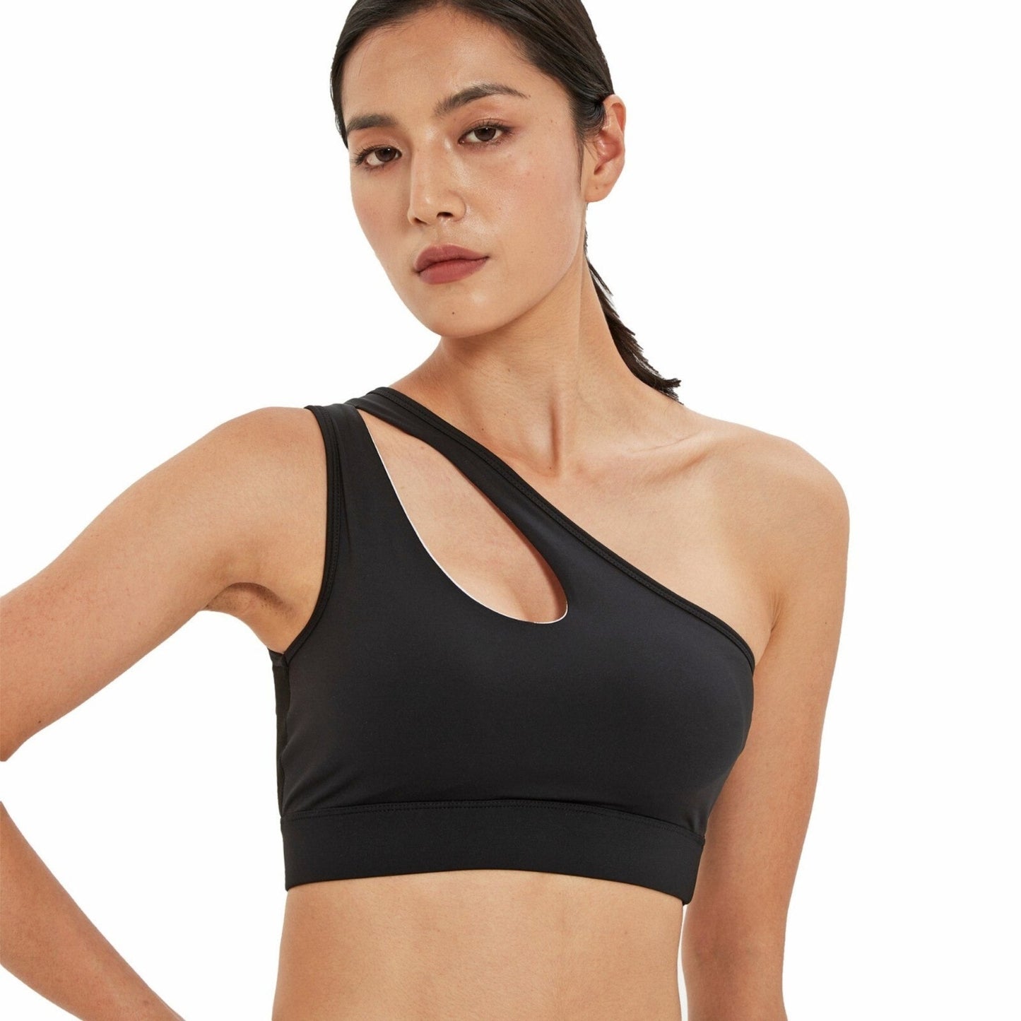 FITNESS MODEL WEARING A ONE SHOULDER PEEK-A-BOO NECKLINE BLACK, HIGH IMPACT SPORTS BRA FROM VIBRAS ACTIVEWEAR.